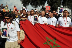 Young Morrocans holdings portraits of King Mohamed VI and a giant national flag, demonstrate in Rabat, on the 35th anniversary of the "Marche Verte" (Green March). On November 6, 1975 the late Moroccan king Hassan II encouraged some 350,000 Moroccans armed with the Koran and the national flag to march to the border with Western Sahara in a show of support for Morocco's annexation of the former Spanish colony. A former Spanish colony, the Western Sahara was annexed by Morocco in 1975. The Polisario Front, backed by Algeria, wants a referendum under the aegis of the United Nations on attachment to Morocco, independence or self-determination under Moroccan sovereignty. AFP PHOTO / ABDELHAK SENNA (Photo credit should read ABDELHAK SENNA/AFP/Getty Images)